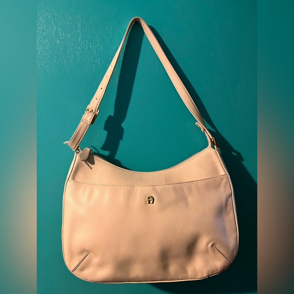 Used Aigner cream colored leather handbag.